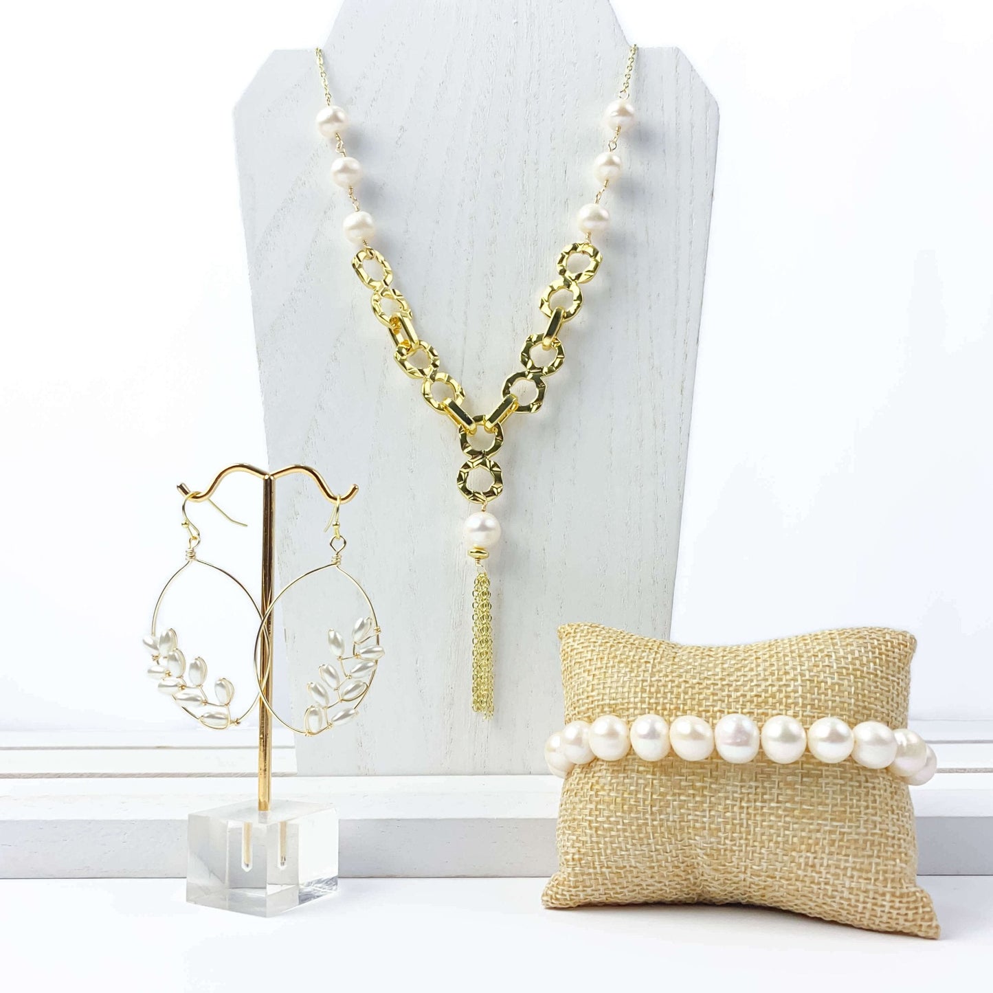 Empowering pearl and gold chain y necklace with tassel detail